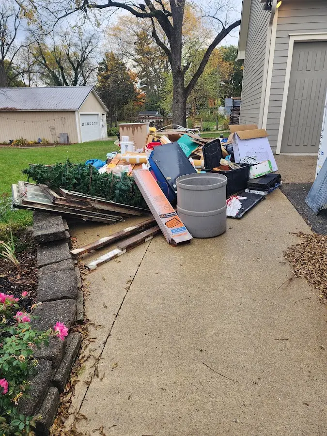 Dumpster being loaded with debris for Estate Cleanout Dumpster Rental in Kennebunkport